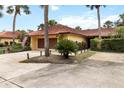 Beautiful one-story home with tile roof, paver driveway, and lush tropical landscaping creating curb appeal at 5057 Maui Cir # 15, Orlando, FL 32808