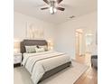 A well-lit bedroom featuring a neutral color scheme, with a view to the en-suite bathroom at 519 Cadiz Dr, Davenport, FL 33837