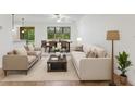 Bright living room features a dining area, comfortable seating, and abundant natural light from large windows at 519 Cadiz Dr, Davenport, FL 33837
