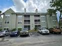 Rear exterior of building features green siding and covered screened in porches at 5980 Westgate Dr Dr # 202, Orlando, FL 32835