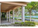 Inviting covered porch with elegant columns, offering scenic views of the serene lakeside community at 7184 Maleberry Run, Winter Garden, FL 34787