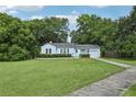Charming single-story home with a sidewalk and mature trees provides inviting curb appeal at 826 Garden Plz, Orlando, FL 32803