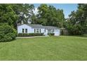 Charming single-story home with a well-manicured lawn and mature trees provides inviting curb appeal at 826 Garden Plz, Orlando, FL 32803