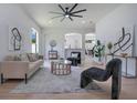 Bright living room featuring modern decor, stylish furniture, and a ceiling fan at 912 Pickfair Ter, Lake Mary, FL 32746