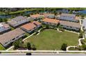 Bird's-eye view of modern townhomes surrounding a well-manicured green space and community park at 10072 Sunnifa Aly, Orlando, FL 32832