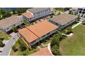 Aerial view of a modern townhome showcasing a tile roof, neat landscaping, and outdoor living space at 10072 Sunnifa Aly, Orlando, FL 32832