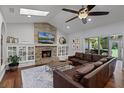 Cozy living room featuring a stone fireplace and a comfortable leather sofa at 105 Laurel Oak Dr, Longwood, FL 32779