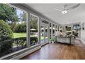 Bright sunroom with large windows offering stunning views of the backyard at 105 Laurel Oak Dr, Longwood, FL 32779