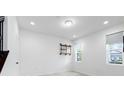 Bright room featuring clean white walls, tile flooring, a window with blinds, and minimalist shelving at 12216 Encore At Ovation Way, Winter Garden, FL 34787