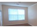 Well-lit living room featuring a big window, blinds, neutral paint, and hardwood floors at 13584 Turtle Marsh Loop # 12, Orlando, FL 32837