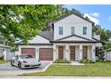 Elegant two-story home featuring a three-car garage, with modern design and a luxury sports car at 1780 Mizell Ave., Winter Park, FL 32789