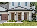 Beautiful front entrance with craftsman style doors and manicured landscaping at 1780 Mizell Ave., Winter Park, FL 32789