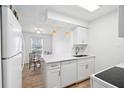 Bright eat-in kitchen features white cabinets, and stainless appliances at 200 St Andrews Blvd # 601, Winter Park, FL 32792