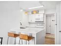Bright white kitchen with modern cabinets, white countertops and stainless appliances at 200 St Andrews Blvd # 601, Winter Park, FL 32792