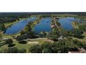 Expansive aerial view of a lake community with long winding waterways and lush greenery at 20130 Sunset Landing Ave, Groveland, FL 34736