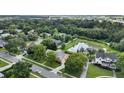 Neighborhood aerial showcasing property's location, mature trees, and proximity to a pond in a serene setting at 205 Trail Bridge Ct, Winter Garden, FL 34787