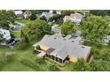 Spacious backyard, screened lanai, and meticulous landscaping in this elevated perspective of the home at 205 Trail Bridge Ct, Winter Garden, FL 34787
