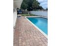 Backyard pool featuring a brick paver surround and well-maintained privacy fence at 229 Doverwood Rd, Fern Park, FL 32730