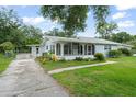 Exterior shot of home featuring a well-kept lawn and a lovely, spacious screened-in front porch at 2538 Meadowview Ln, Deland, FL 32720