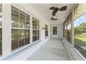 View of the home's screened-in porch and front door at 2538 Meadowview Ln, Deland, FL 32720