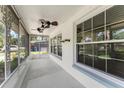 View of the home's screened-in porch featuring an overhead fan and large windows at 2538 Meadowview Ln, Deland, FL 32720