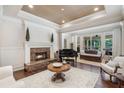 Spacious living room featuring a fireplace, piano, and bright natural light at 25554 Hawks Run Ln, Sorrento, FL 32776