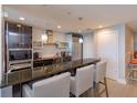 Modern kitchen with a countertop bar, pendant lights, and stainless steel appliances at 260 S Osceola Ave # 902, Orlando, FL 32801