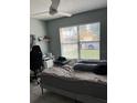 Relaxing bedroom with a comfortable bed, fan, and a bright window at 2833 Woodruff Dr, Orlando, FL 32837
