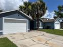 Lovely single-story home showcasing a well-kept lawn, driveway, and pleasant blue exterior at 2833 Woodruff Dr, Orlando, FL 32837