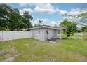 Back exterior view of gray single-story home with a fenced in yard and AC Unit at 311 Cortland Ave, Winter Park, FL 32789