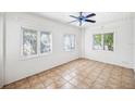 Bright living room with white walls, tile floors, ceiling fan, and natural light at 311 Cortland Ave, Winter Park, FL 32789