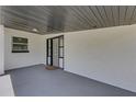 Covered front porch with gray flooring, offering a welcoming entrance to the home at 3430 Arbutus Ln, Winter Park, FL 32792