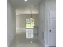 Hallway leading to outdoor scenery with a sliding glass door at 3431 Orchid Dr, Indian Lake Estates, FL 33855