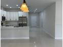 Open concept living space featuring tile flooring and modern light fixtures at 3431 Orchid Dr, Indian Lake Estates, FL 33855