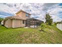 Home's backyard features a screened-in pool and lush green grass at 3816 Eagle Isle Cir, Kissimmee, FL 34746