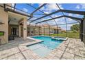 Clear swimming pool with connected spa and screened-in enclosure at 3816 Eagle Isle Cir, Kissimmee, FL 34746