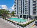 Exterior swimming pool outside of the Park Lake Towers with lounge seating and sunny skies at 400 E Colonial Dr # 1501, Orlando, FL 32803