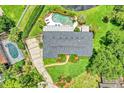 Aerial view of home with private pool, manicured landscaping, and circular driveway at 400 Timbercove Pl, Longwood, FL 32779