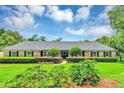Charming single-story home with manicured lawn, symmetrical landscaping, and inviting entryway at 400 Timbercove Pl, Longwood, FL 32779