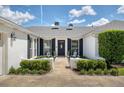 Charming front exterior featuring a green yard, a brick house, and black shutters at 417 Monticello Dr, Altamonte Springs, FL 32701