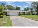 Attractive home with a large driveway, two-car garage, and arched entryway at 419 W Orange St, Altamonte Springs, FL 32714