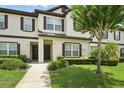 Charming townhouse exterior featuring manicured landscaping and a welcoming entrance at 600 Northern Way # 607, Winter Springs, FL 32708