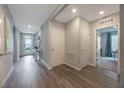 Bright entryway featuring wood-look flooring and white doors, inviting and well-lit at 736 Mocking Jay Ln, St Cloud, FL 34771