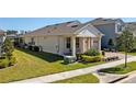Home's exterior featuring a well-manicured lawn and partially covered patio area with nice greenery at 8935 Sonoma Coast Dr, Winter Garden, FL 34787