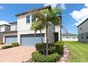 Inviting townhouse with brick driveway, lush landscaping, and a two-car garage, offering curb appeal and convenience at 1024 Desert Candle Dr, Ocoee, FL 34761