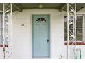 Close-up of the home's front door featuring decorative details at 105 N Florida Ave, Howey In The Hills, FL 34737