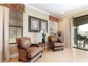 Cozy sitting area with comfortable wicker chairs, natural light, and view of the outdoor patio at 1156 Castle Pines Ct, Reunion, FL 34747