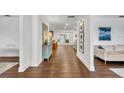 Inviting hallway showcasing hardwood floors, white walls, and modern decor leading to open living spaces at 137 N Spring Lake Dr, Altamonte Springs, FL 32714