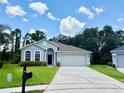Charming single-Gathering home with a well-manicured lawn and a two-car garage at 14700 Chadbury Ct, Orlando, FL 32828