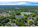 Beautiful aerial shot of the property with stunning lake views and the city skyline in the distance at 1609 E Kaley Ave, Orlando, FL 32806